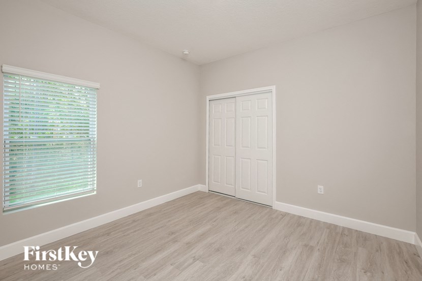 the second bedroom with a door and a window