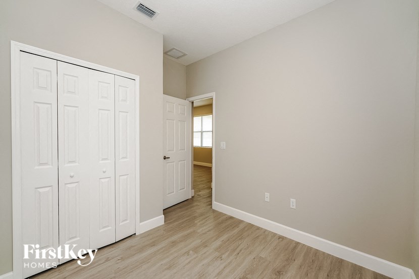 a bedroom with two closets and a door to a hallway