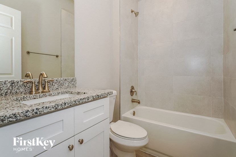 a bathroom with a toilet and a tub and a sink