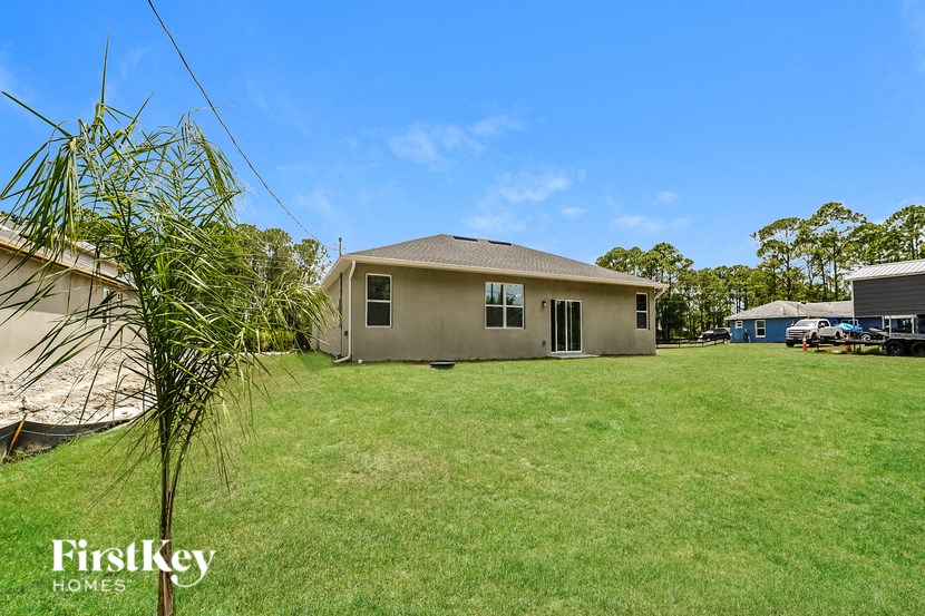 a house with a yard and a palm tree