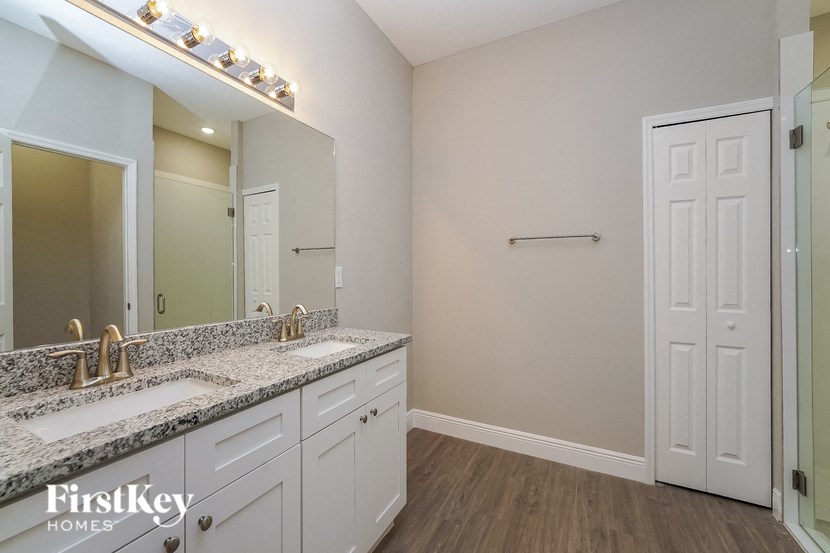 a bathroom with two sinks and a large mirror