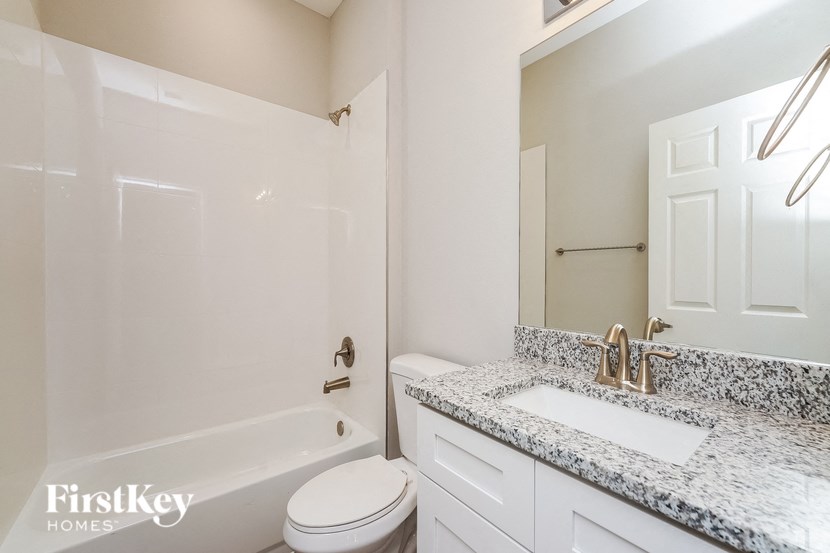 a bathroom with a sink and toilet and a shower