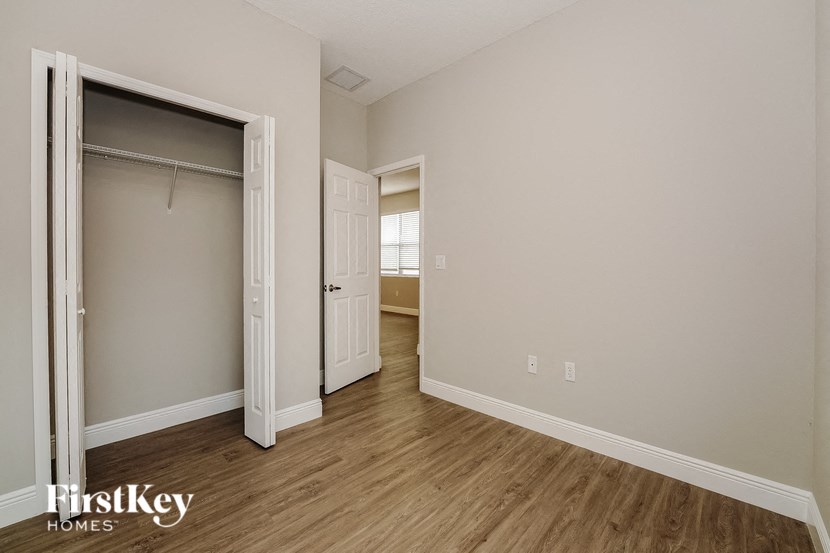 a bedroom with a closet and a door to a bathroom