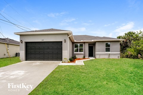 a white house with a black garage door