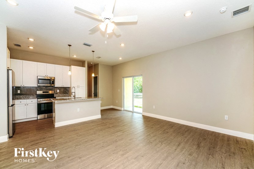 the living room is open to the kitchen and dining area