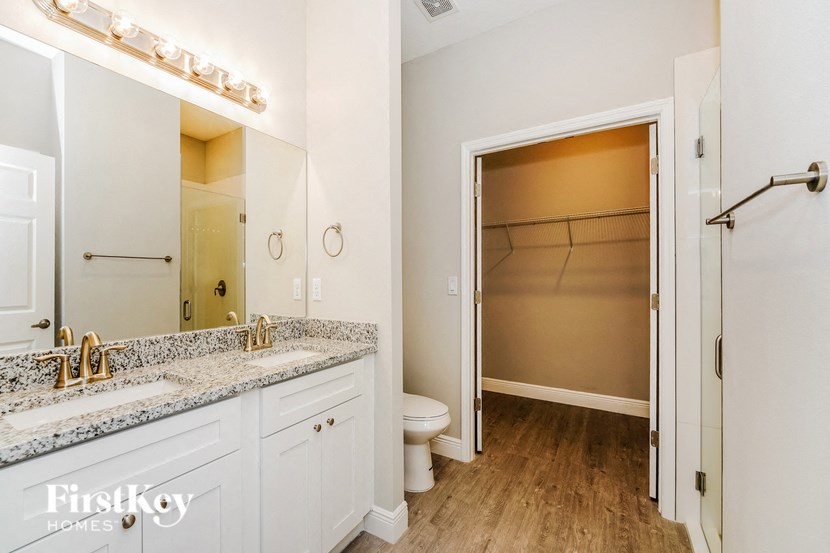 a bathroom with a shower and a sink and a toilet