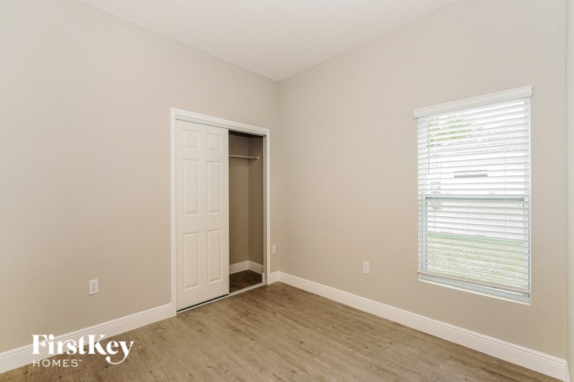 a bedroom with a closet and a door to a closet