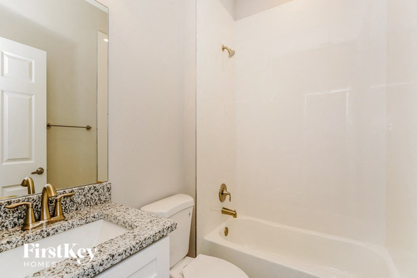 a bathroom with a shower toilet and sink and a bath tub