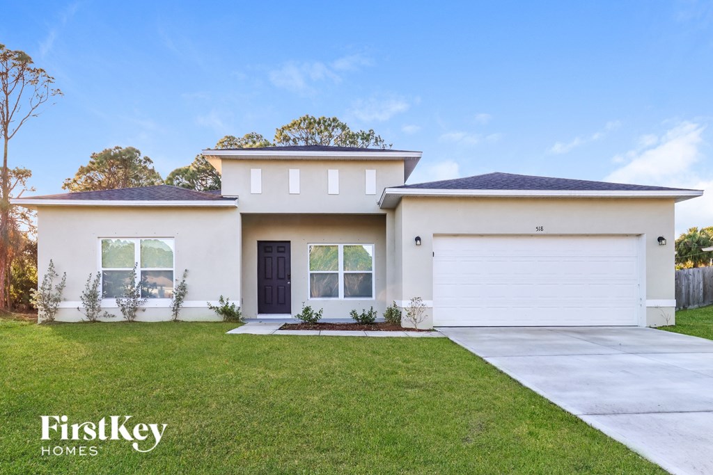 A modern house with a black door and a garage.