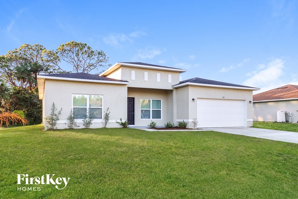 A modern house with a white garage door and a black roof.