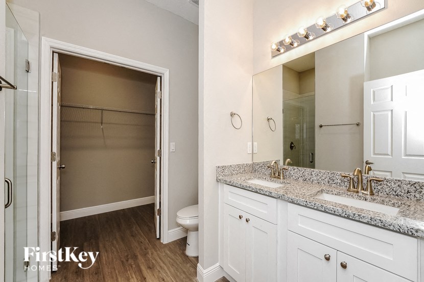a bathroom with a toilet and a sink and a mirror