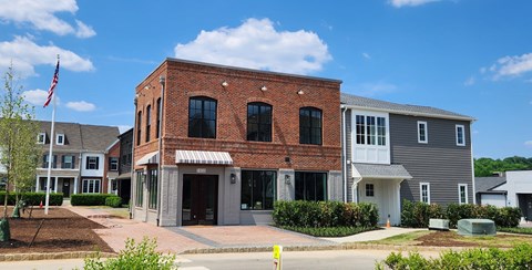 a brick building with an flag in front of it