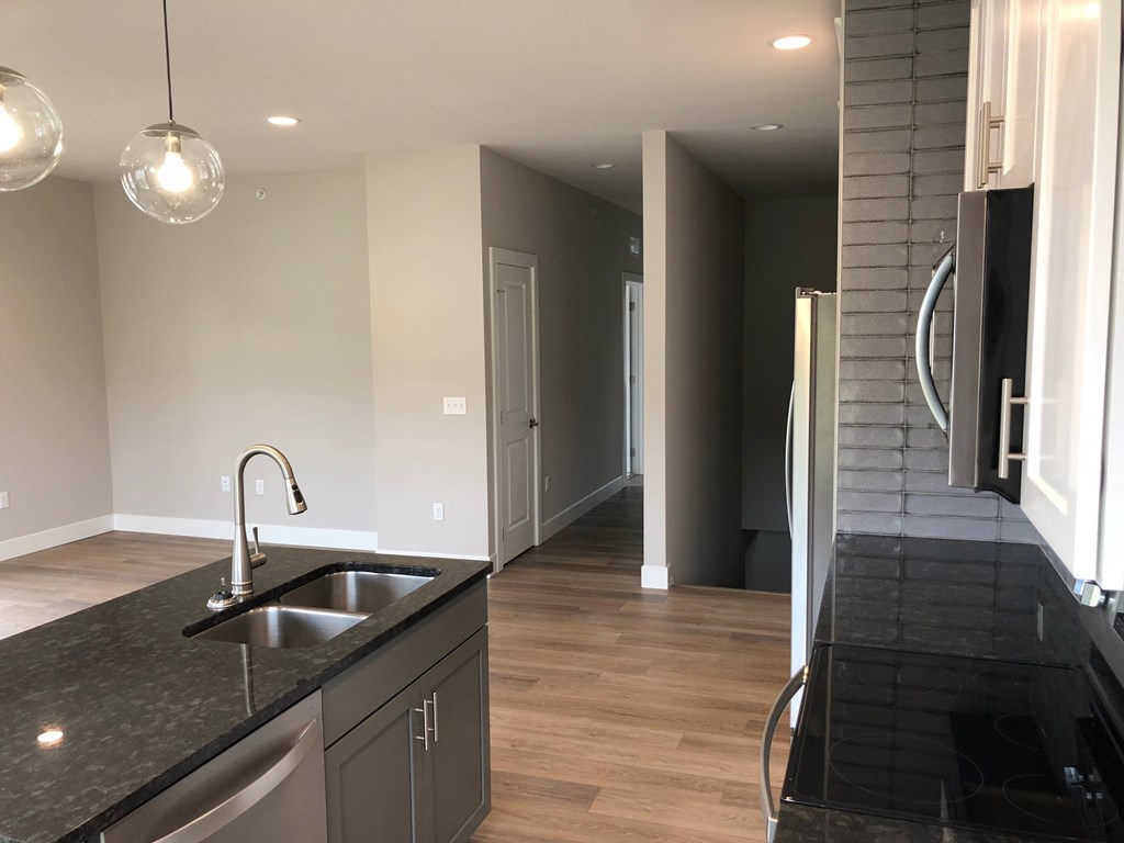 a view from the kitchen into the hallway and the living room
