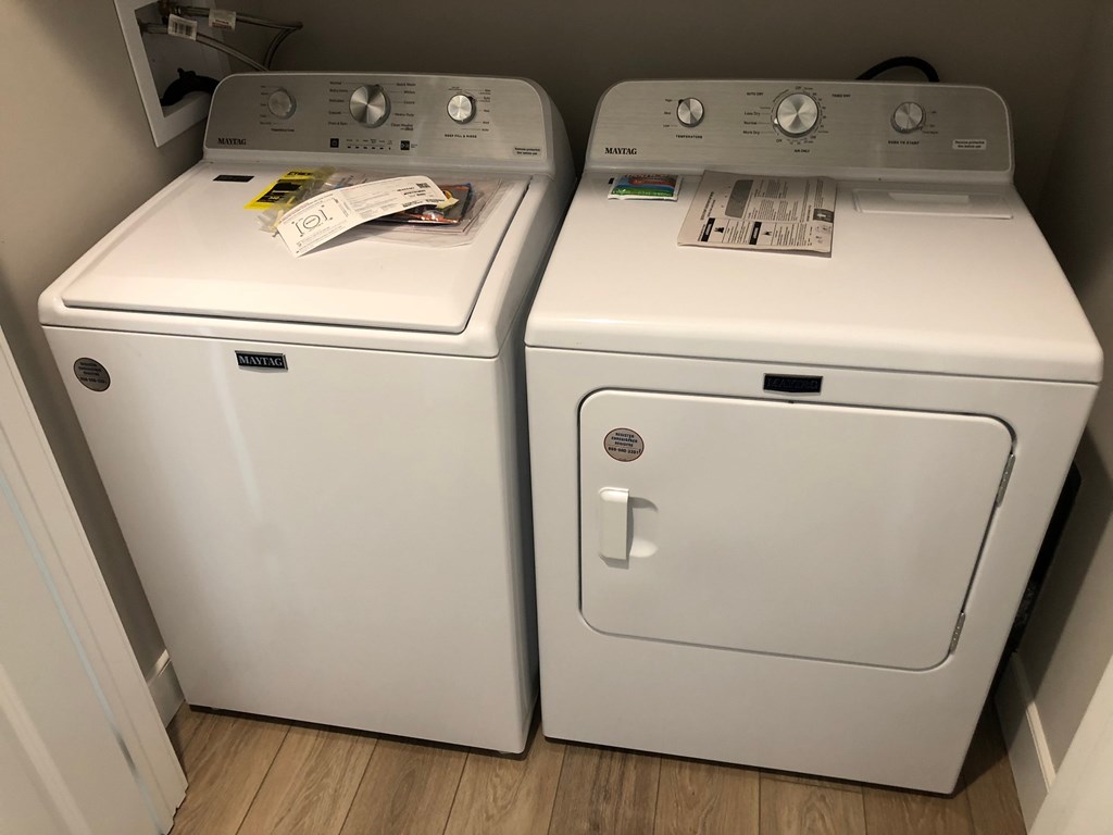 two white washers and dryers sitting next to each other