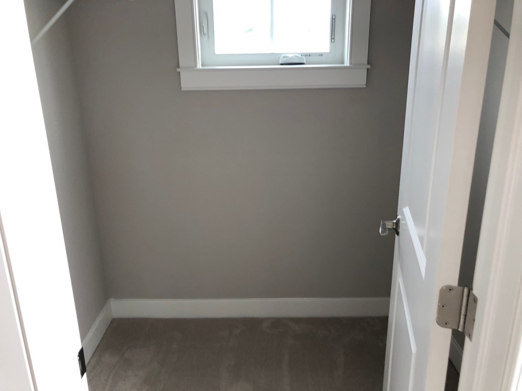 a small room with a window and a door