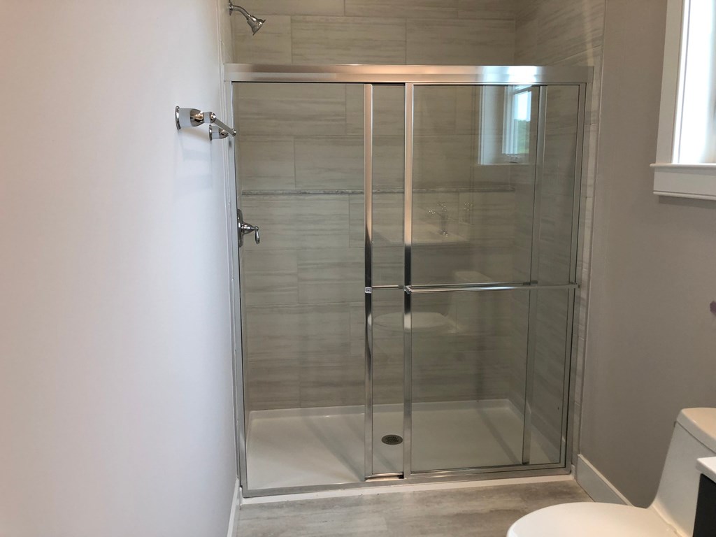 a shower with a glass door in a bathroom