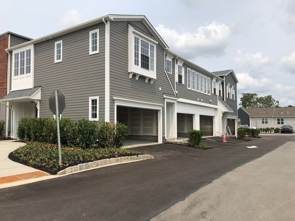 a gray house with a stop sign in front of it