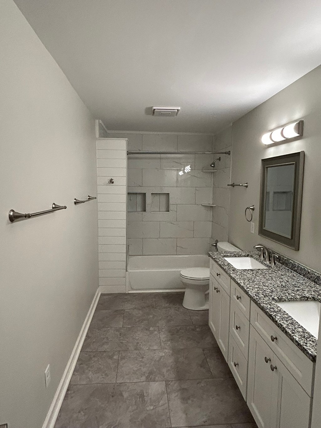 A bathroom with a walk-in shower and a toilet.