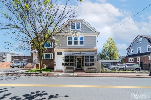 the front of a house with a street in front of it