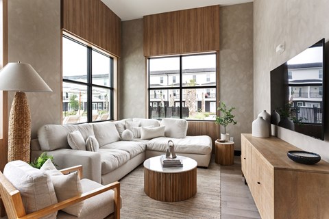 A living room with a white couch and a wooden coffee table.