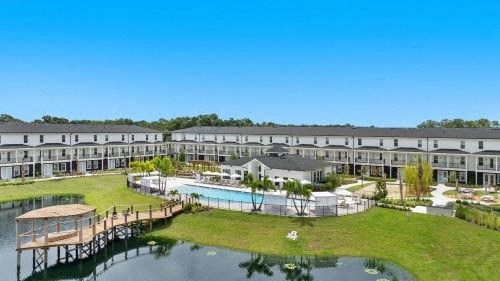 an aerial view of a resort with a swimming pool