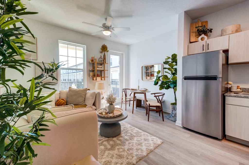 an open living room with a kitchen and a dining room