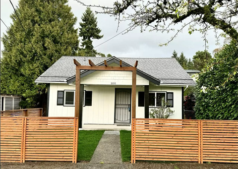a house with a wooden fence in front of it