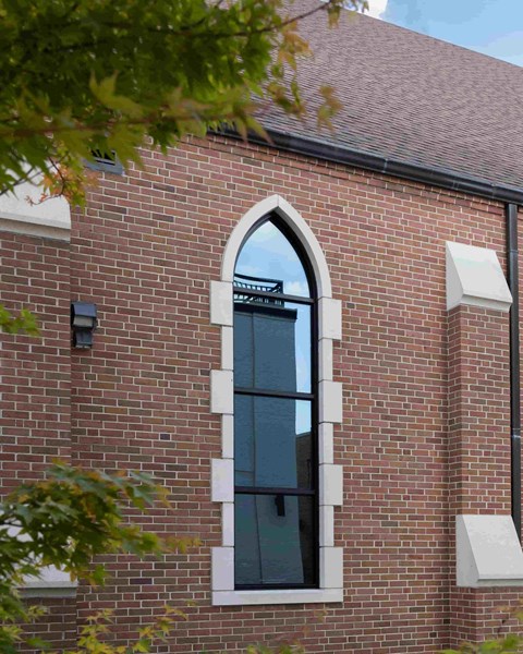 a window on the side of a brick building