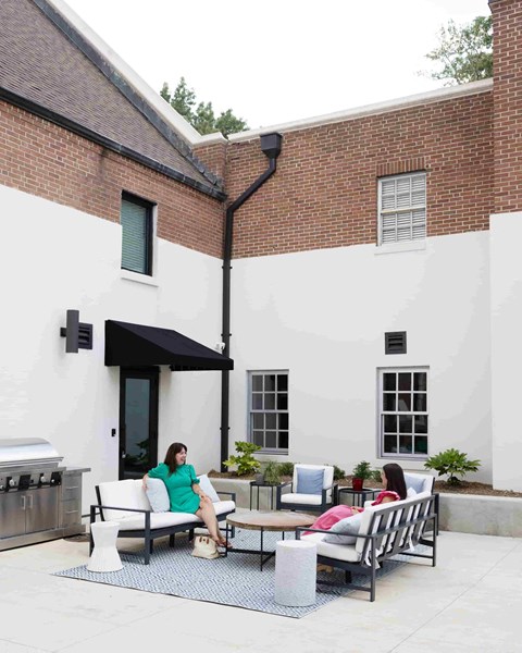 a woman sitting on a bench outside of a building