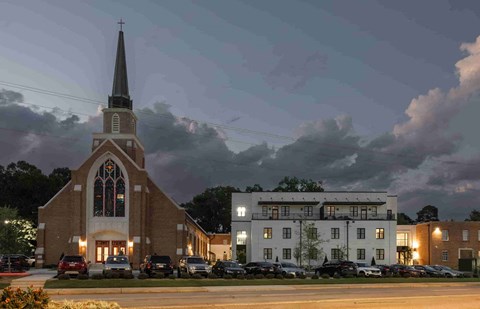 a church at night with a street in front of it