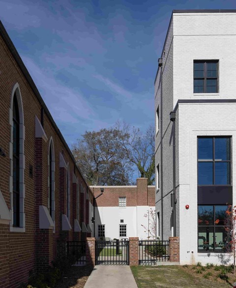 a courtyard between two buildings on a sunny day