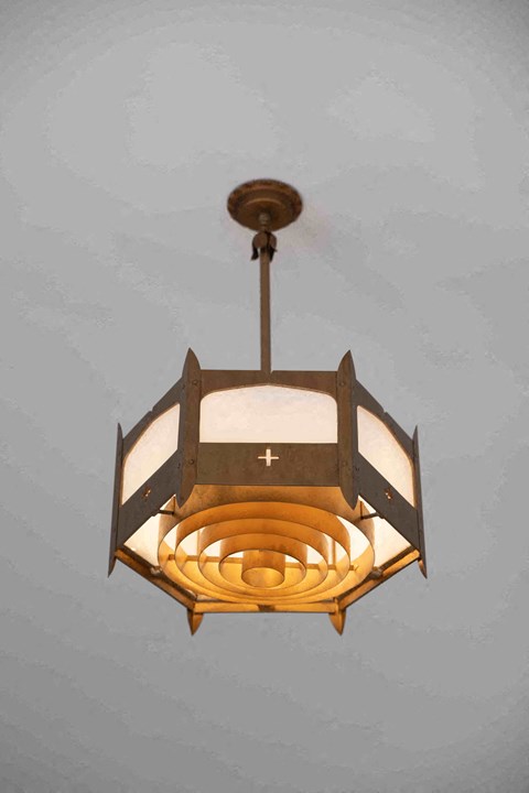 a light fixture hanging from the ceiling of a church