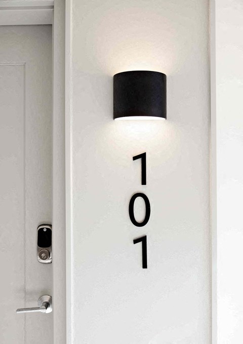 a white door with the numbers and a light on top of it