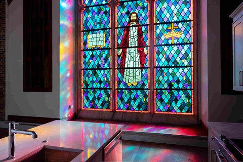 a stained glass window in a kitchen with a counter top