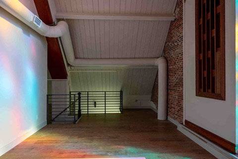 a view of the inside of a building with a large empty room with a railing