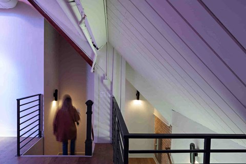 a woman walking down the stairs in a building