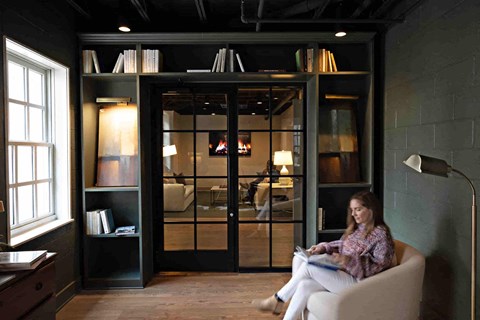 a woman sitting in a chair in a living room