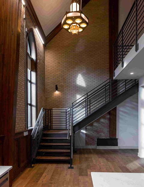 a view of a staircase in a building with brick walls and wood floors