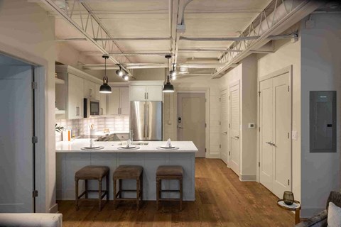 a large kitchen with a large island with three stools
