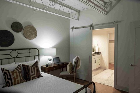 a bedroom with a bed and a closet and a bathroom