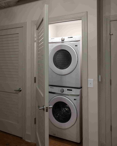a front loading washer and dryer in a small closet