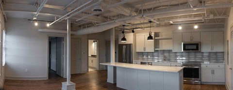 a large kitchen with white cabinets and a white counter top
