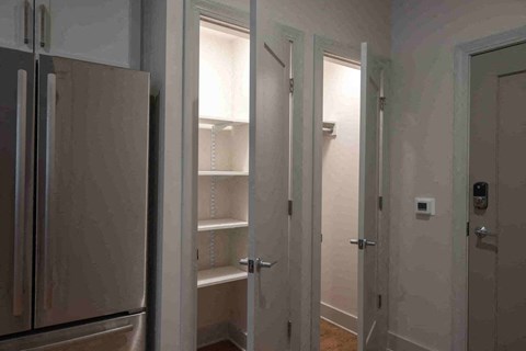 a room with a closet and a refrigerator