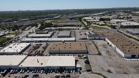 an aerial view of an industrial parking lot and buildings