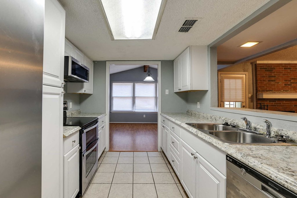 a kitchen with a sink and a stove and a window