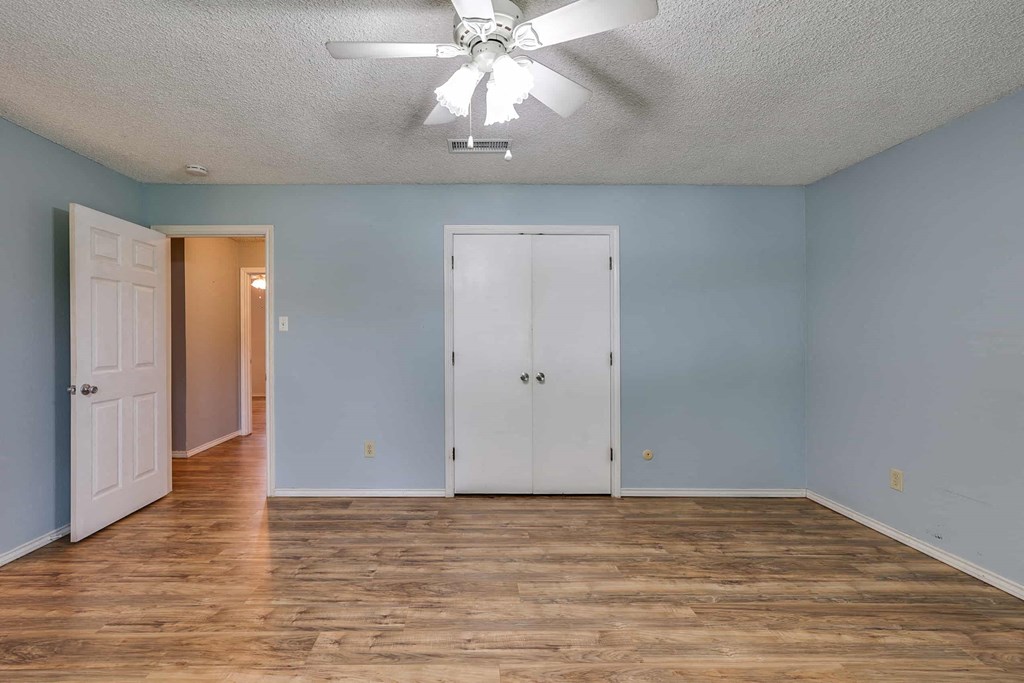 a living room with blue walls and a ceiling fan