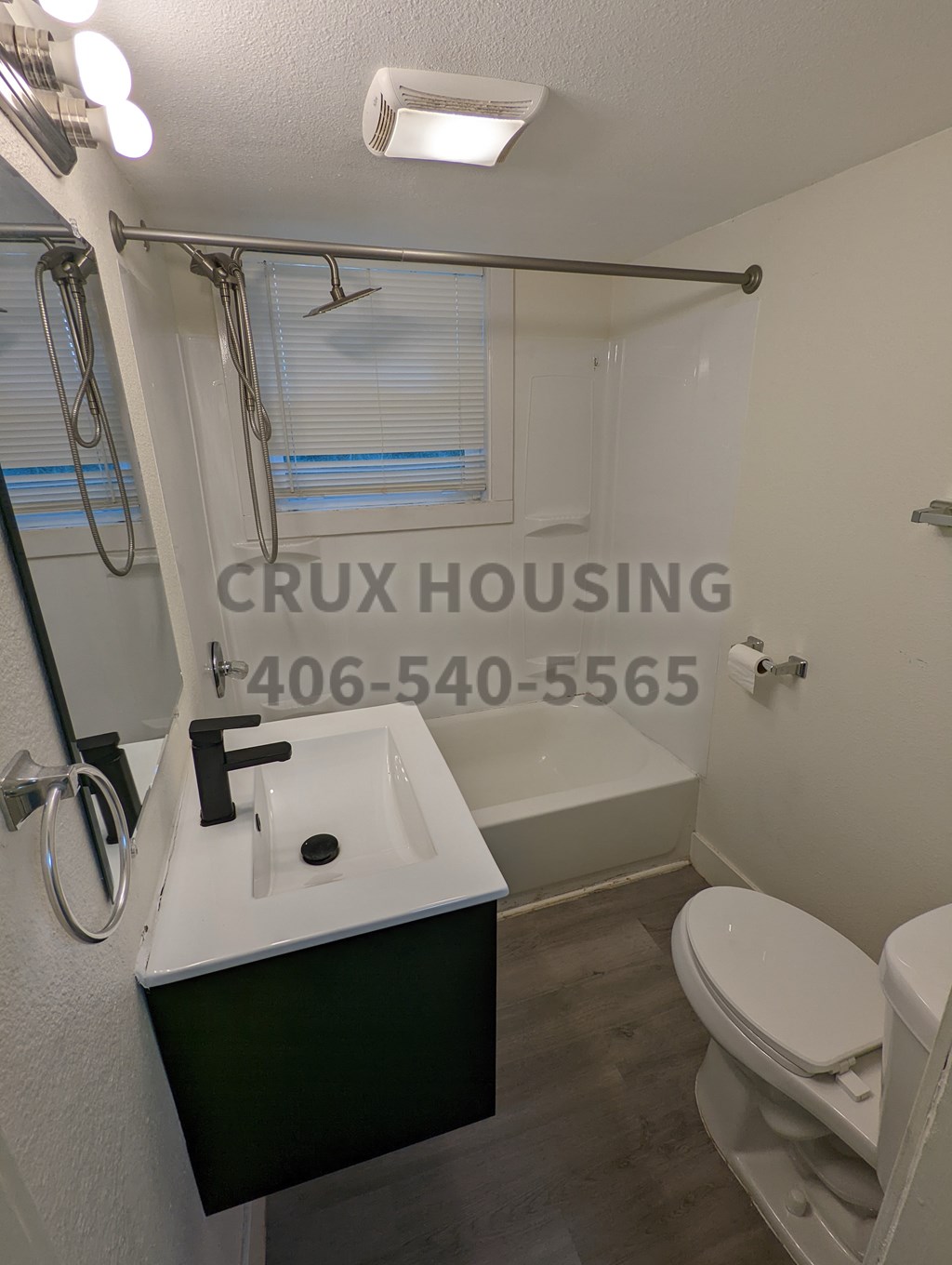 A bathroom with a toilet, sink, and a shower curtain.