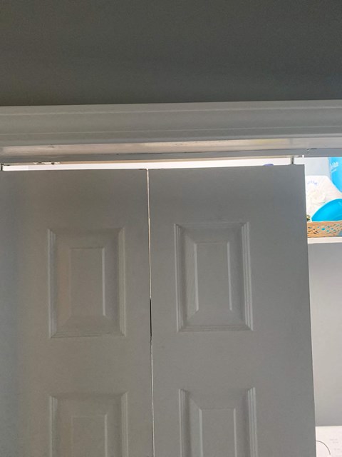 A white door with a window above it.