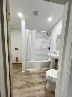 a bathroom with a toilet and a tub and a sink