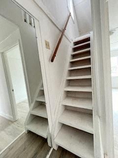a white staircase in a house with a white door